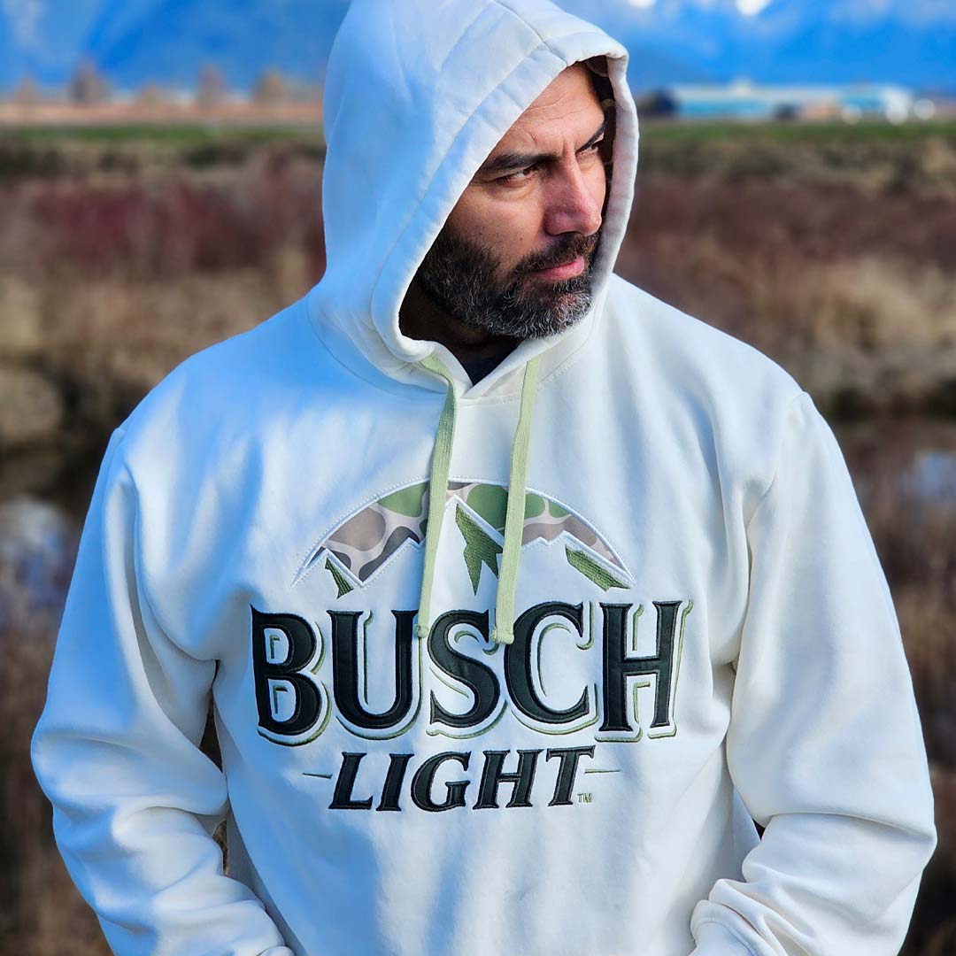 man wearing ivory Busch Light hoodie