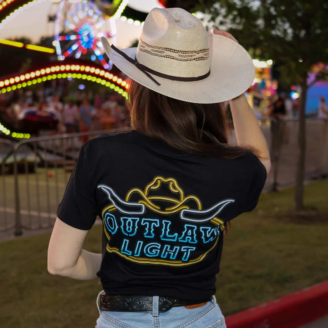 Woman in black Outlaw Light t-shirt