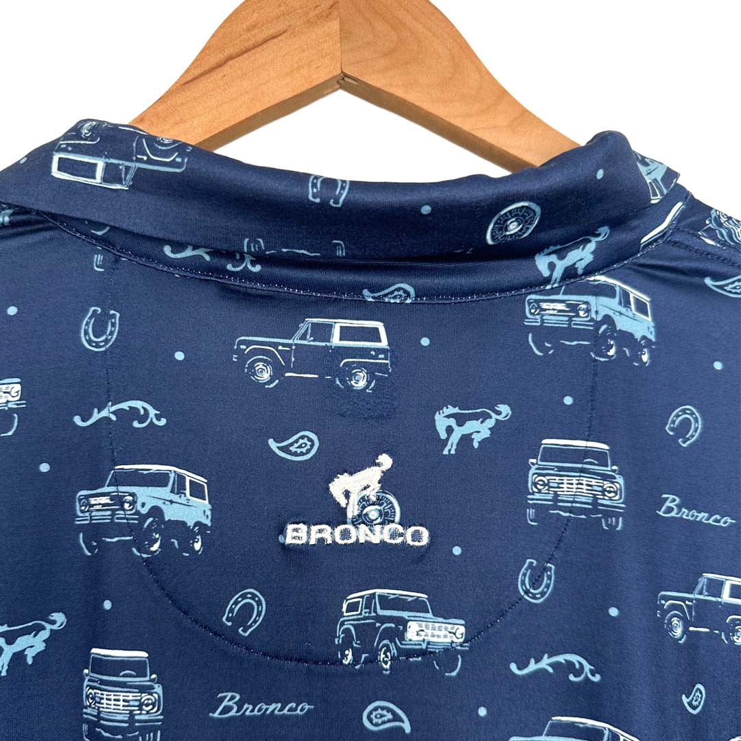 Blue Bronco Vintage Polo shirt with vehicle designs on a white background
