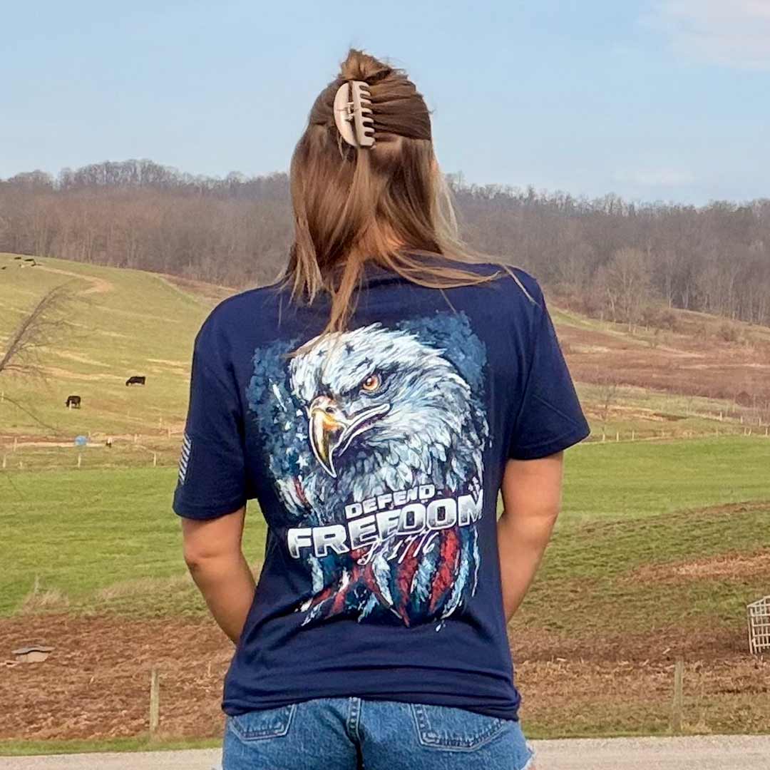woman on a farm wearing a navy blue shirt with an eagle on it