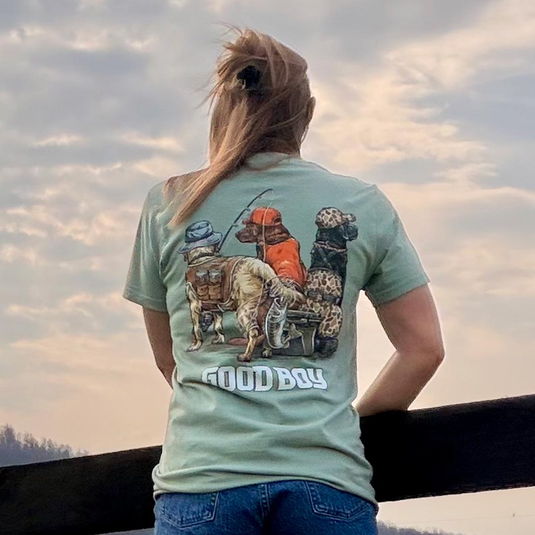 woman on a farm wearing a green shirt with dogs on it