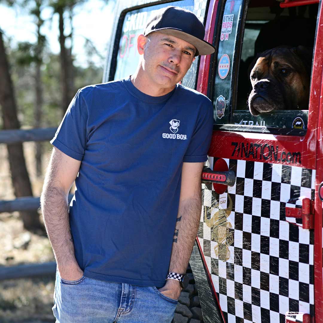 man wearing blue t-shirt with dog and American flag