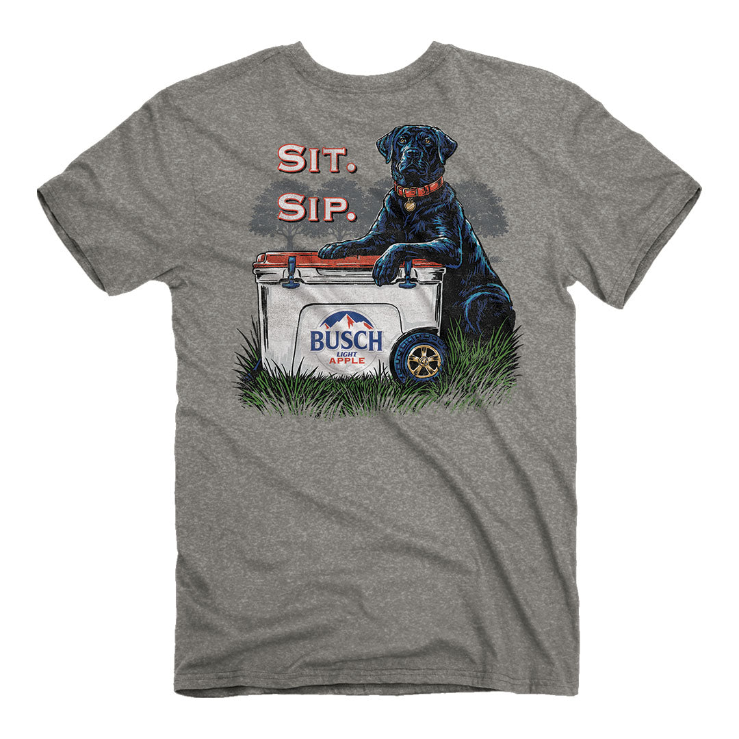 A heather gray crewneck t-shirt featuring a graphic print of a black dog sitting on a white cooler with the text 'SIT. SIP.