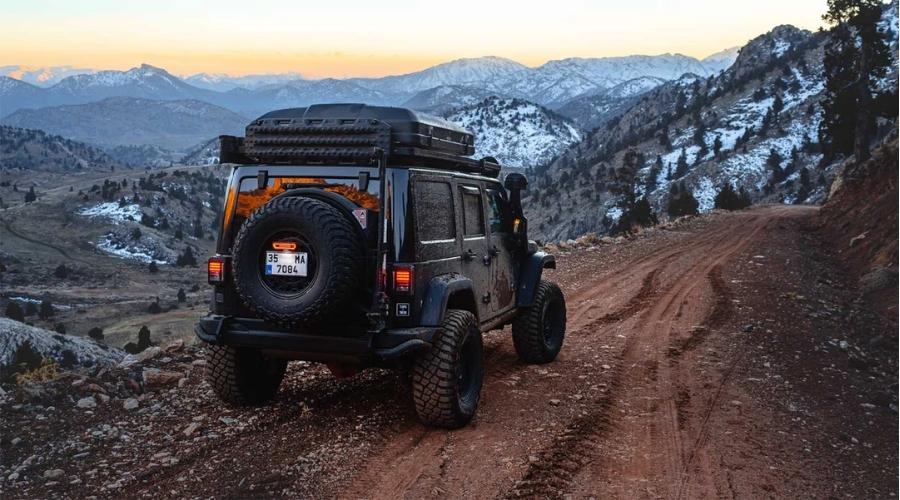 Black Jeep riding down the trail