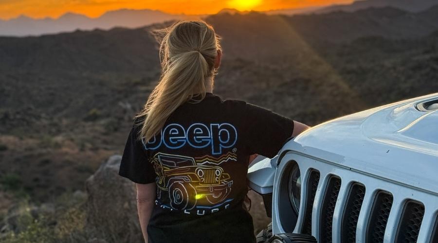 Girl standing outside of her jeep wearing a jeep shirt