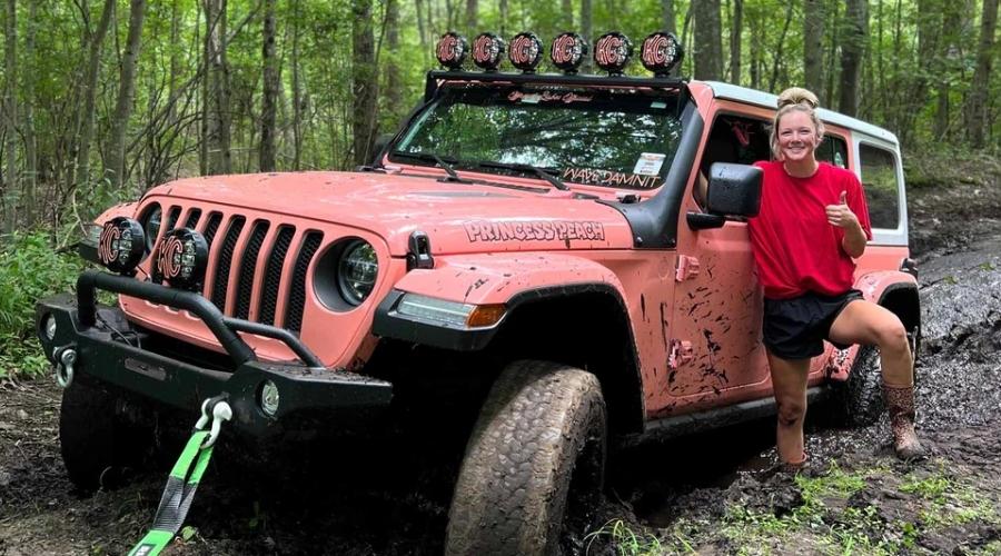 Girl mudding with her pink jeep