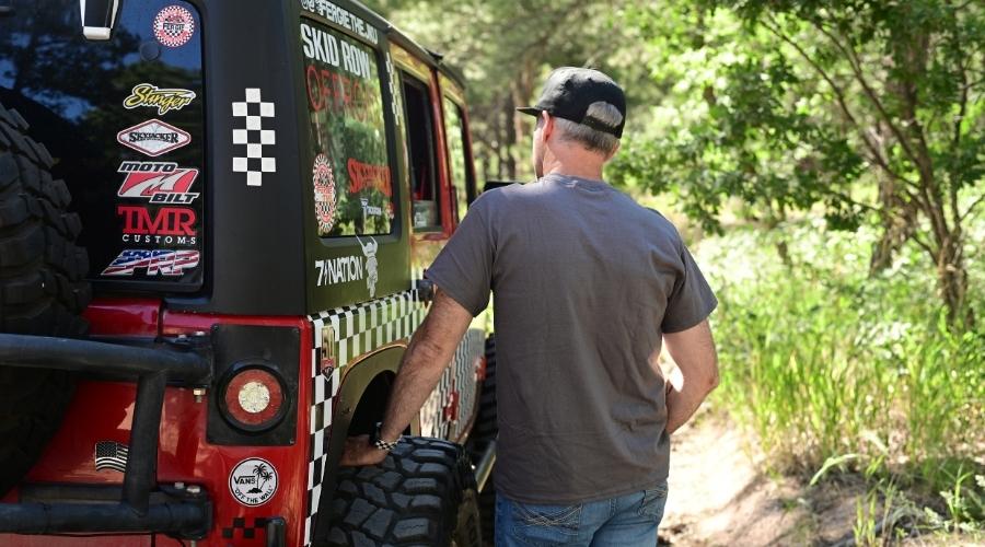 Man cleaning his jeep soft top