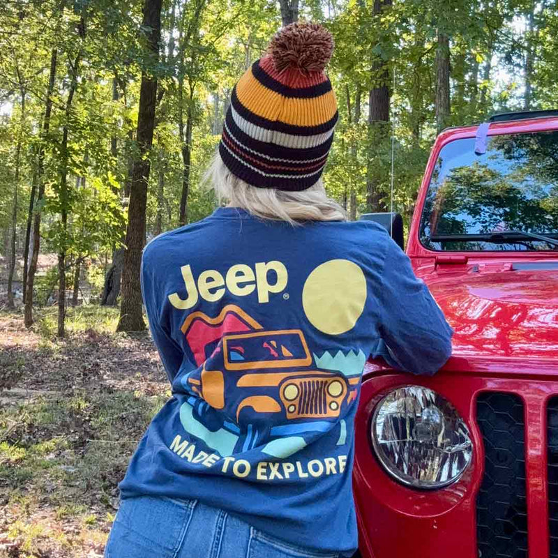 back of long sleeve shirt with a jeep off roading said "made to explore" on a woman in a jeep beanie