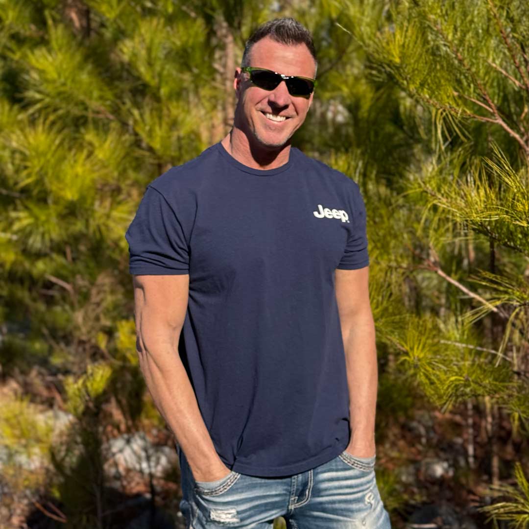 man wearing jeep shirt with brand logo on left chest outdoors