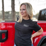 Woman wearing black t-shirt with Busch logo outline on the left chest