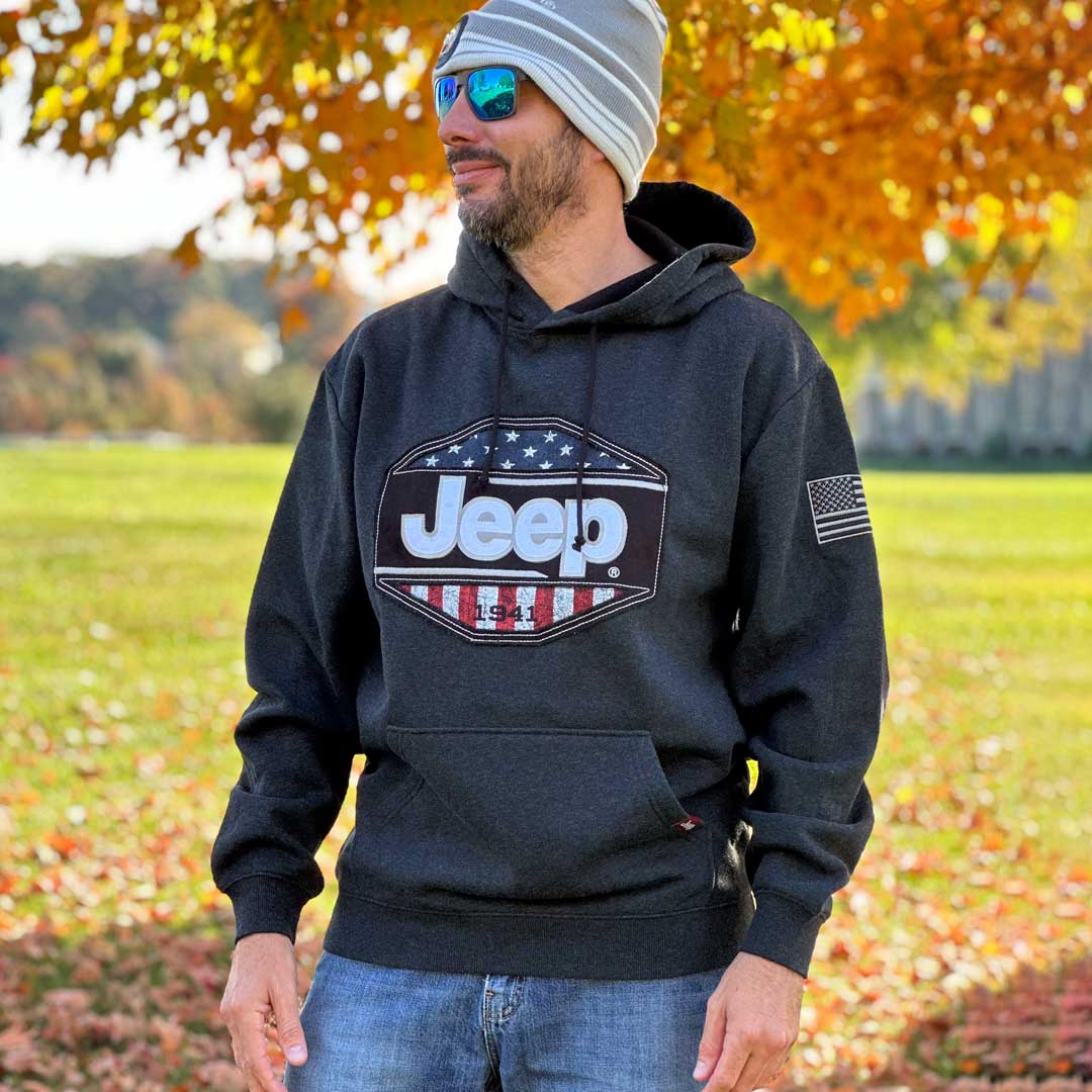 man wearing black hoodie with embroidered Jeep logo and USA Shield