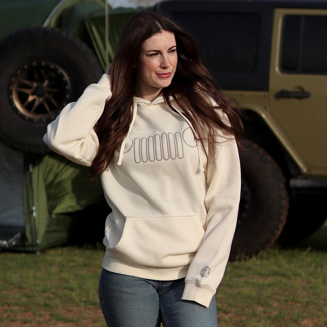 woman wearing a white jeep hoodie with grille on chest