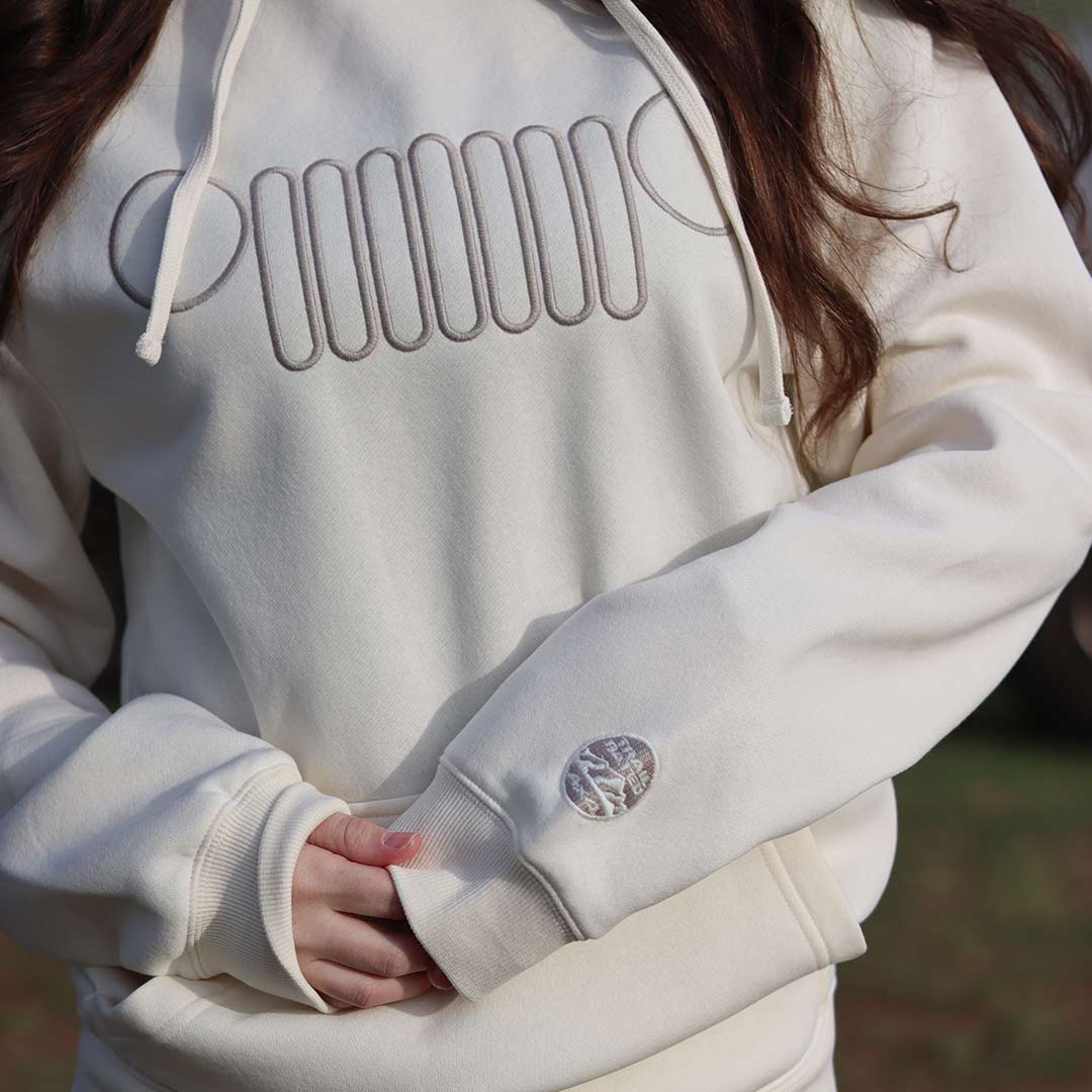 front of white jeep hoodie with jeep grille embroidered on chest and icon on the sleeve