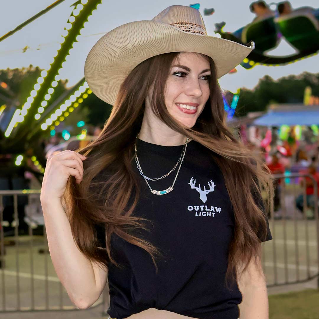 Woman in black Outlaw Light t-shirt