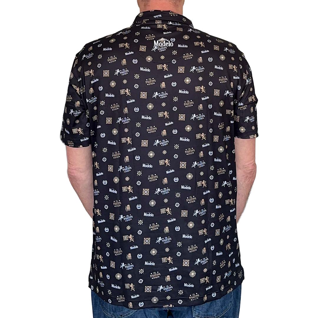 Mack of man wearing a black Modelo Fighting Spirit repeat polo on a white background