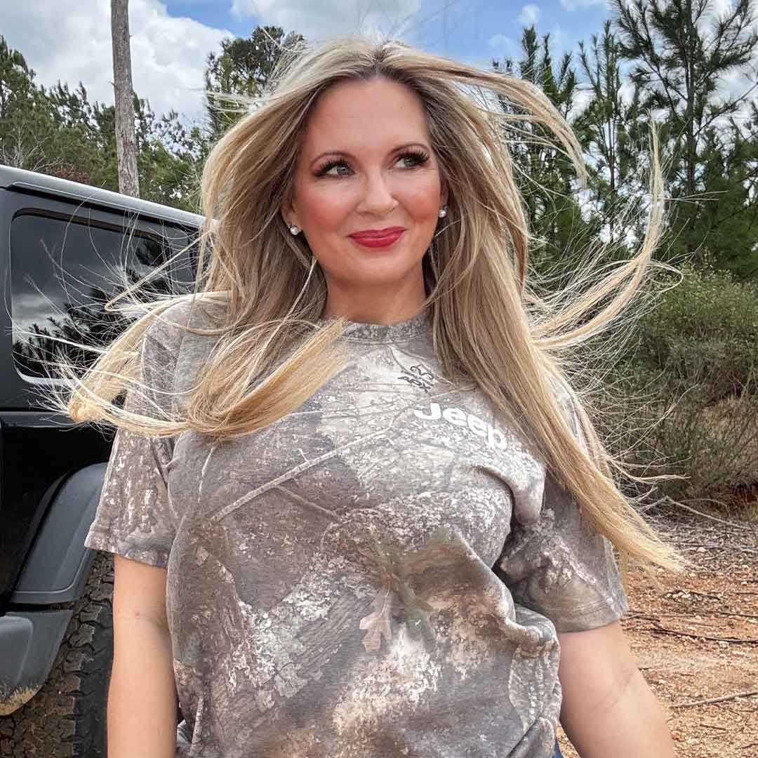 blonde woman in camo t-shirt with jeep on left chest