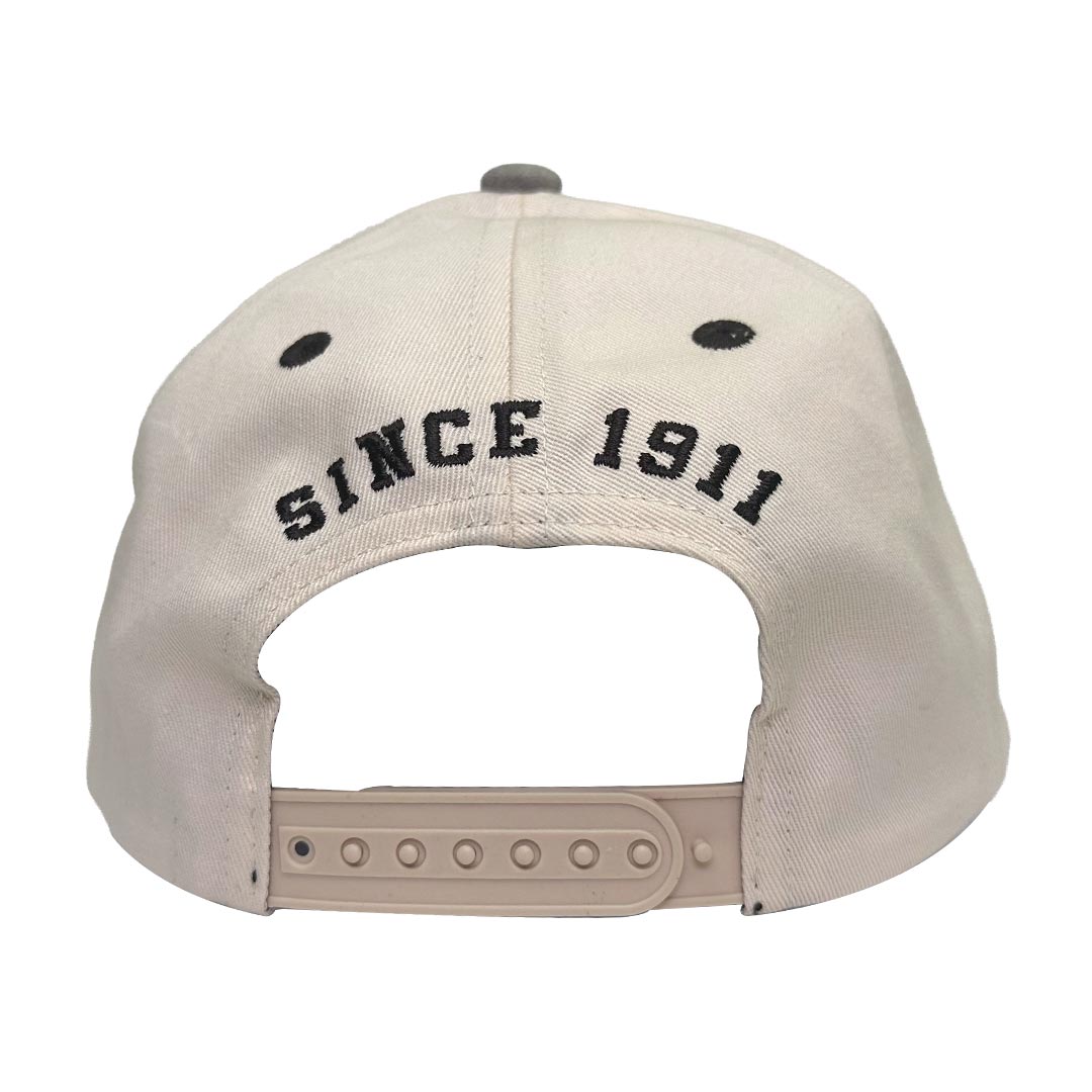 The back of a light beige Chevrolet hat featuring brown embroidered text that reads 'SINCE 1911' and a matching beige adjustable snapback strap.