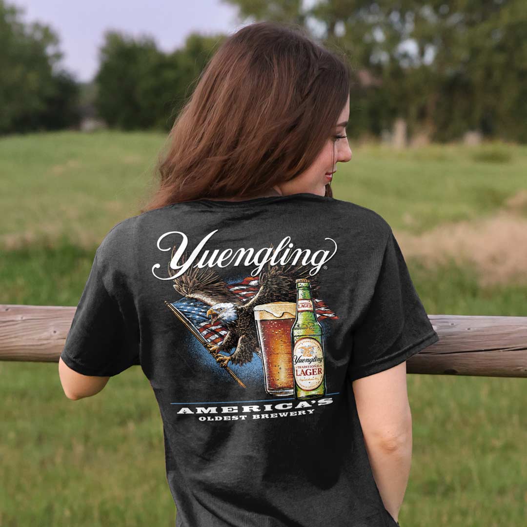 woman in black t-shirt with Yuengling, eagle, and American flag