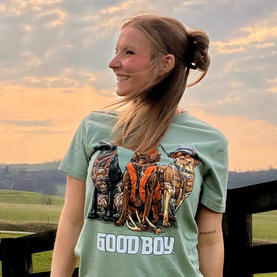 woman on a farm wearing a green shirt with dogs on it