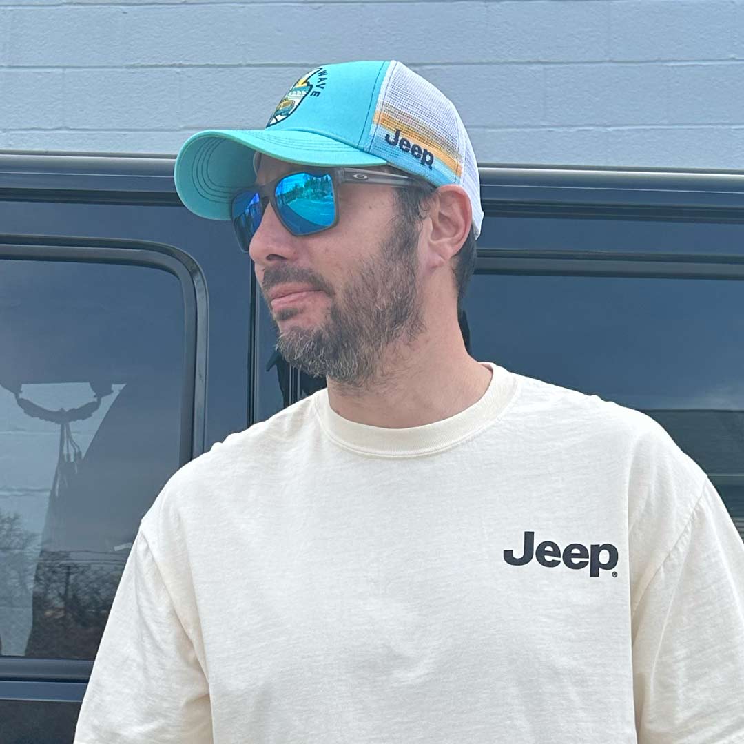 man wearing blue and white Jeep Catch a Wave hat