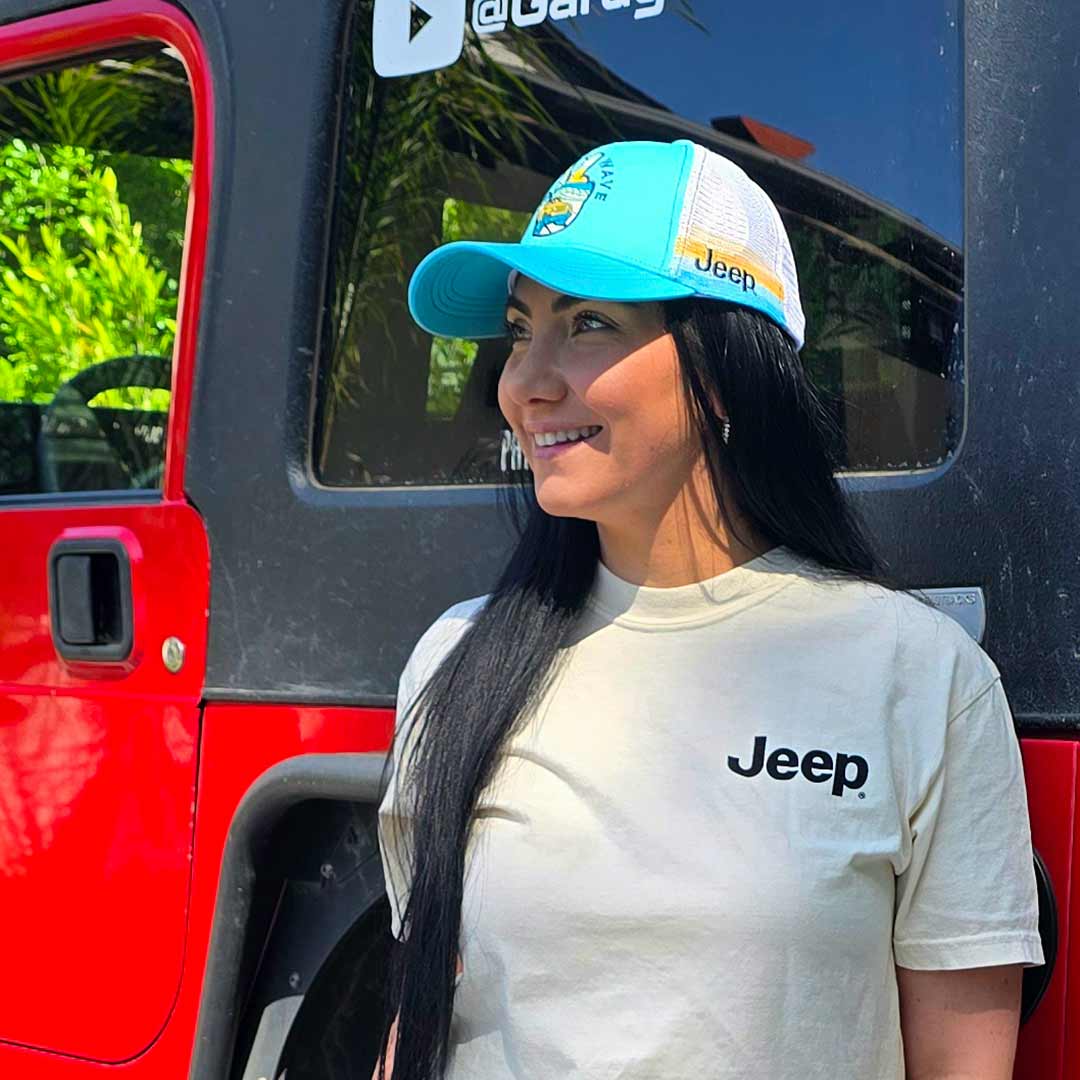 woman wearing jeep t-shirt and blue an orange hat