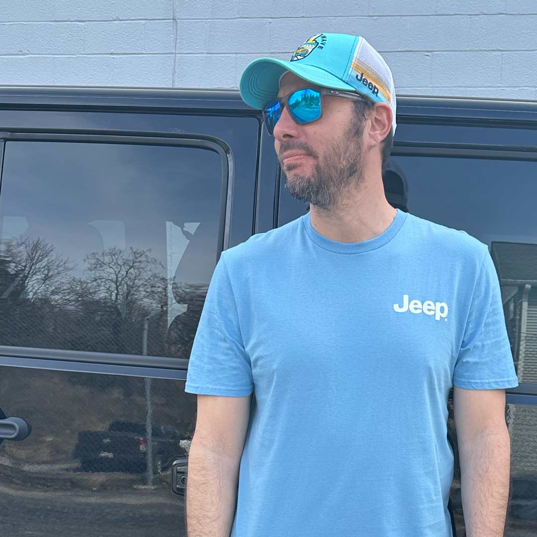 male wearing a Jeep t-shirt and hat, both blue and white